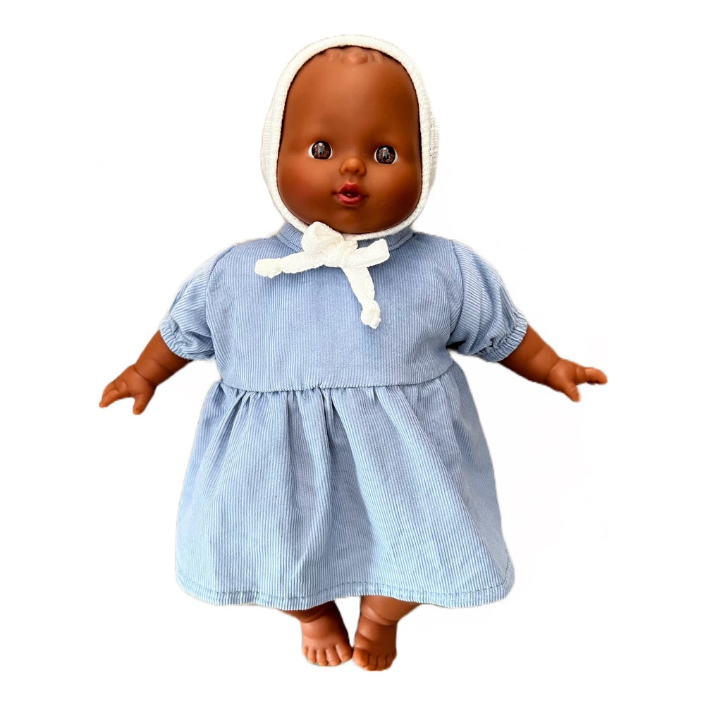 Minikane Soft Baby Girl Doll in Peacock Blue Dress and White Pointelle Bonnet · Black