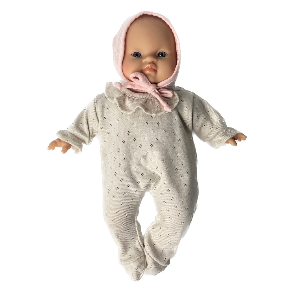 Minikane Soft Baby Girl Doll in Cream Pointelle Romper and Soft Pink Bonnet · Fair